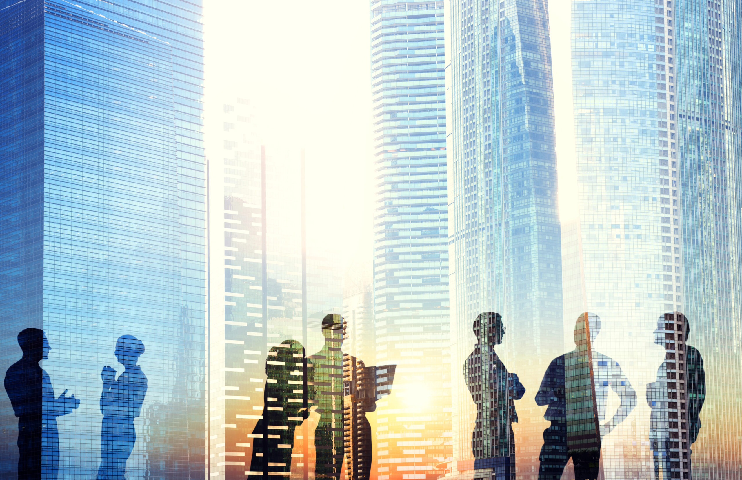 People working outside with city background; abstract